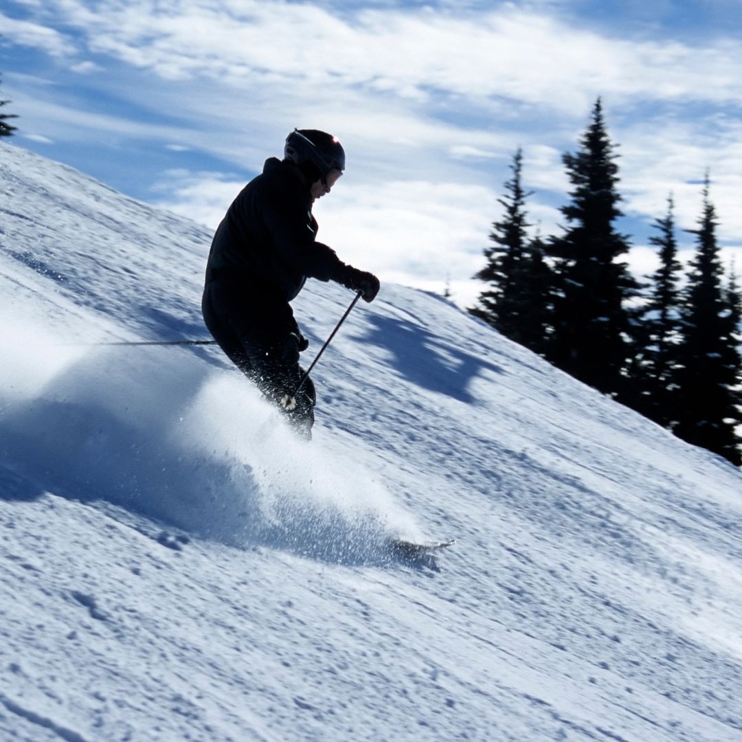 man skiing down mountain