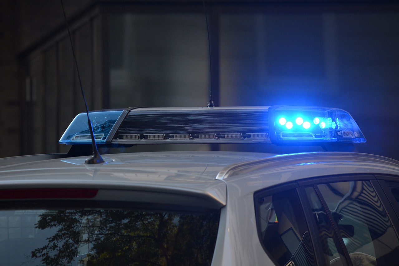 A stock photo of a close up of the headlights on top of a police cruiser with a dark background