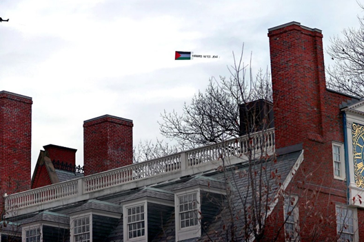 Boston.com photo of plane flying over Harvard with banner that says "Harvard hates Jews"