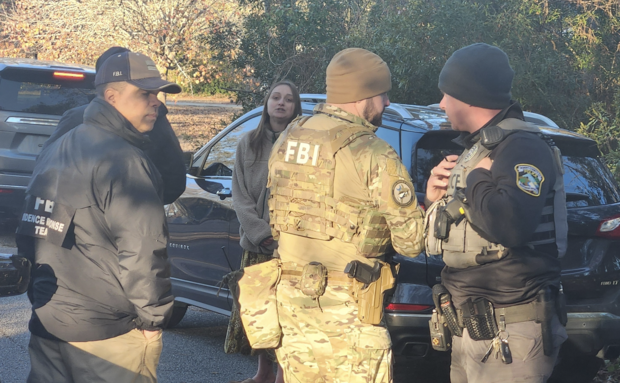 FBI agents and Alexis Hartnett, center. WBTW