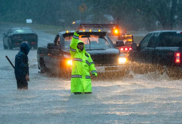 Vehicles plow through a flooded street during heavy rain in Leominster, Massachusetts, on September 11. (Rick Cinclair/Worcester Telegram & Gazette/AP)