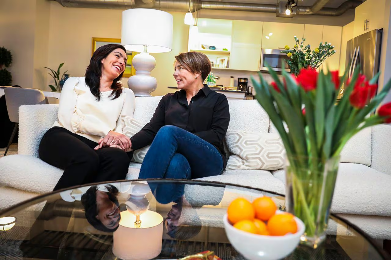 Governor Maura Healey (right) alongside her partner Joanna Lydgate (left). Photo by Erin Clark of The Boston Globe.