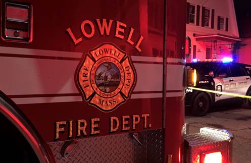 Photo of a Lowell Fire Department fire truck in front of a fire