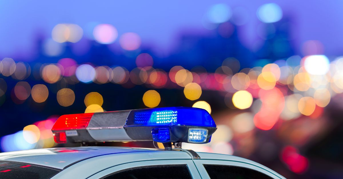 Stock image of the top of a police cruiser with a focus on the headlights from the side.