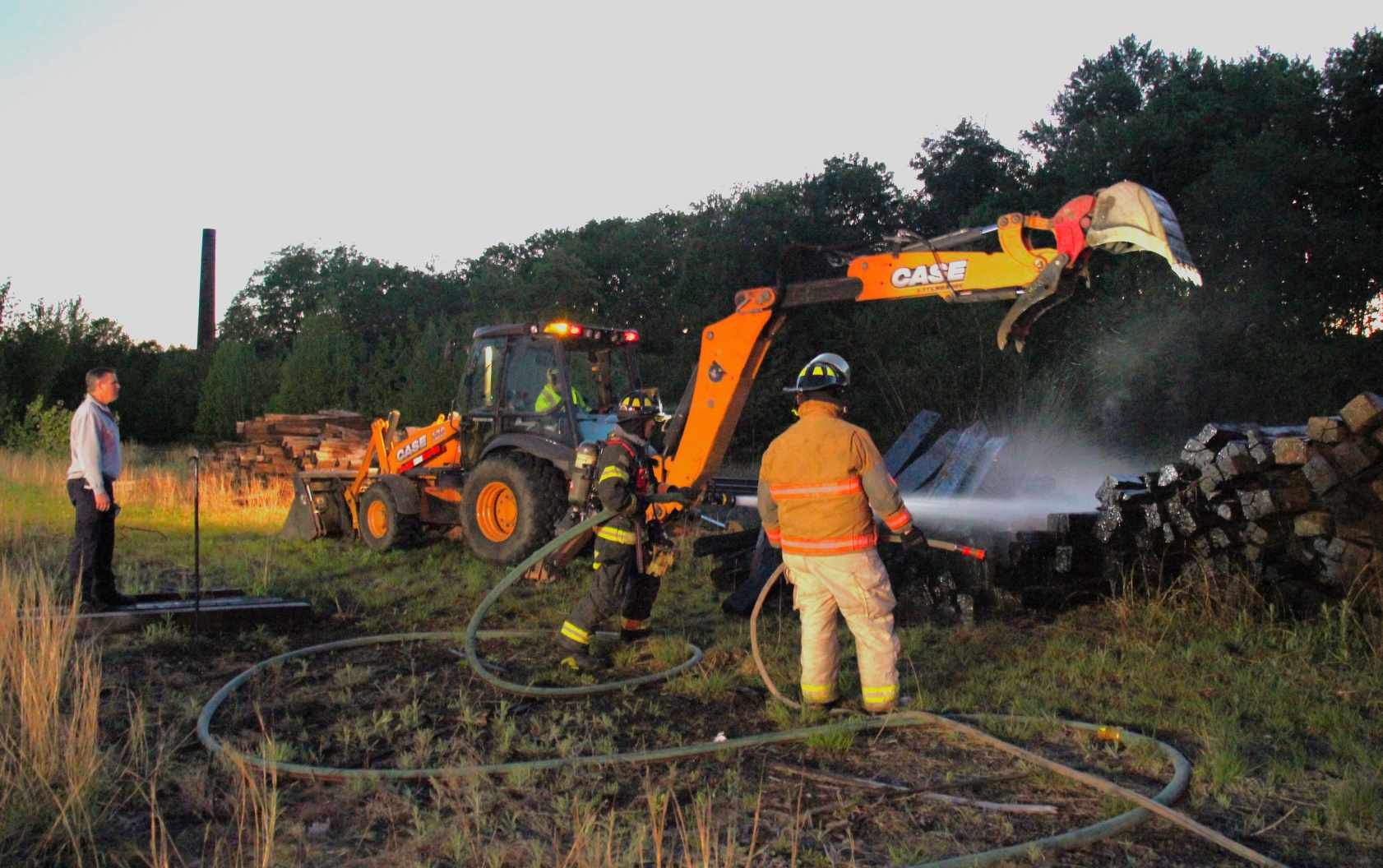 Fire fighters put out a fire found in a pile of railroad ties at the Historic Athol Railroad Station Sunday, May 19, 2024 (Photos Courtesy of Bryan Favreau)