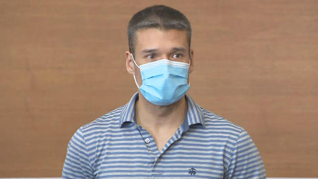 This is a picture of Robert Kawada during his arraignment in Waltham District Court on Tuesday, May 28, 2024. He's wearing a coronovirus mask, has medium-brown skin, looks young for his early 40s, appears to be in shape has a close cut hair cut his hair is brown. (Photo Courtesy of: CBS Boston)
