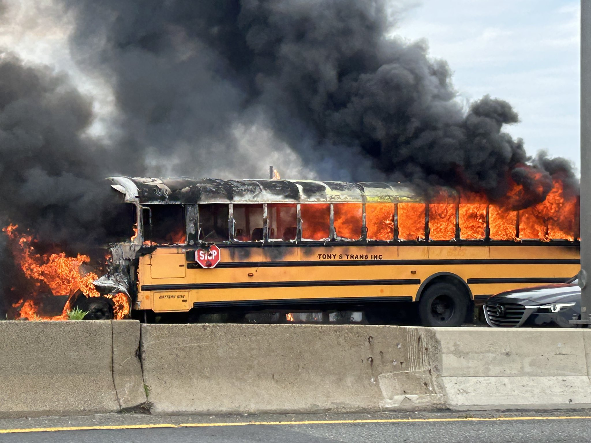 The school bus that caught fire on I-93 in Dorchester Monday afternoon. (Photo: Ben Kowal's Twitter)