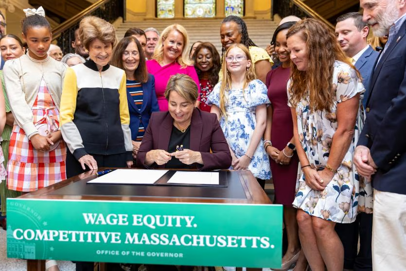 Governor Healey signing An act relative to salary range transparency into law on July 31, 2024. (Photo Credit: Mass.gov)