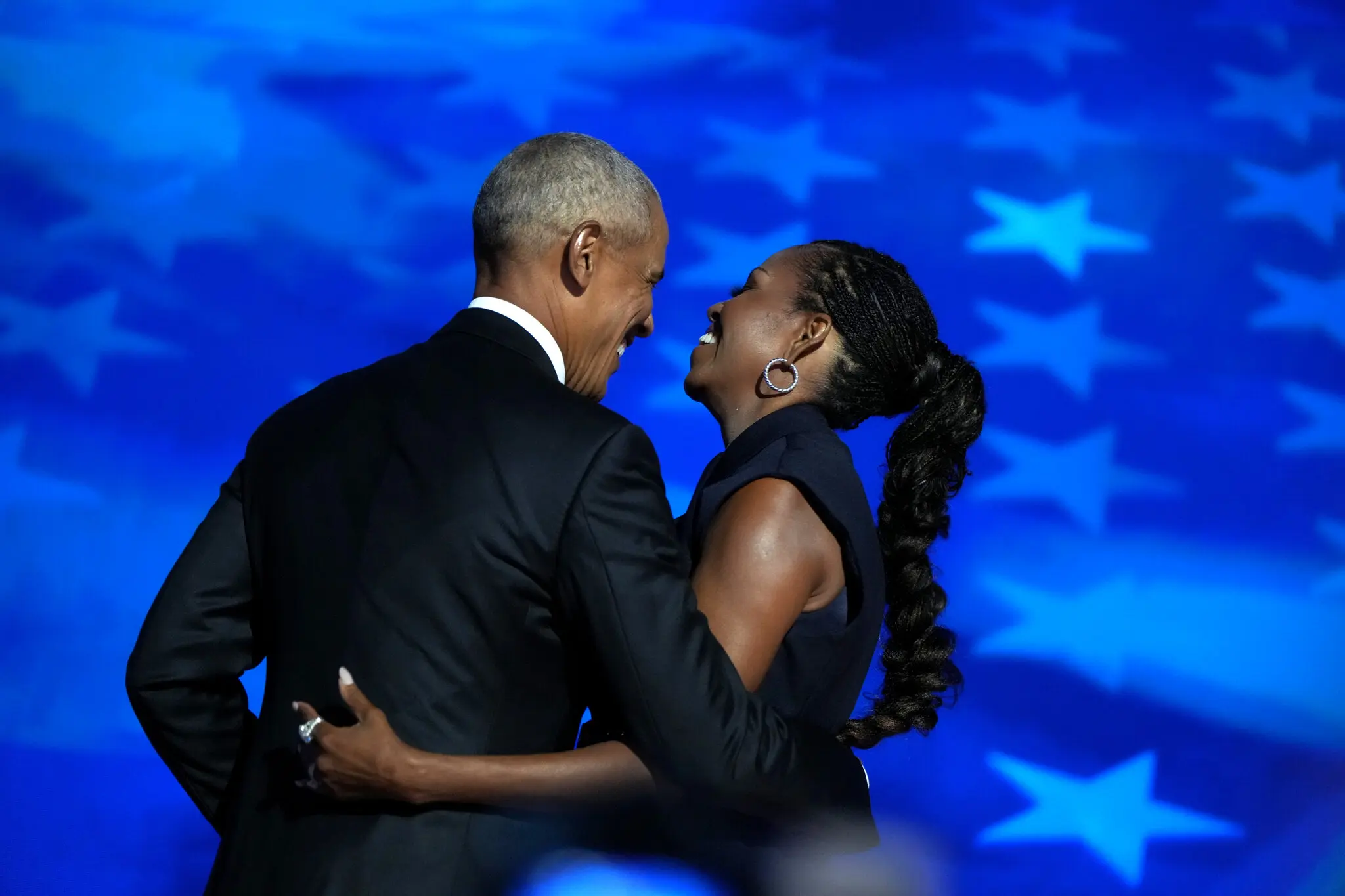 Michelle Obama after her speech and before introducing her husband, Barack Obama, at day 2 of the DNC Convention on Aug. 20, 2024. (Photo Credit: Todd Heisler/The New York Times)
