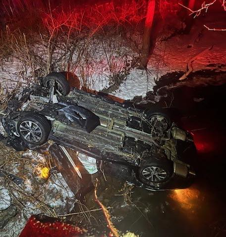 Auburn police rescue woman from car overturned in water; driver charged with DUI