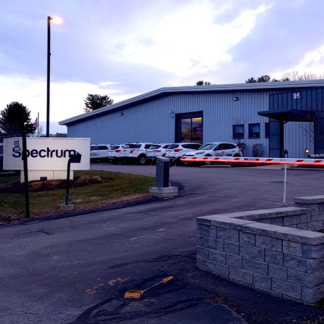 Exterior view of Charter Communications’ Spectrum facility on Higgins Street in Worcester, showing a brick building and signage indicating the call center location.