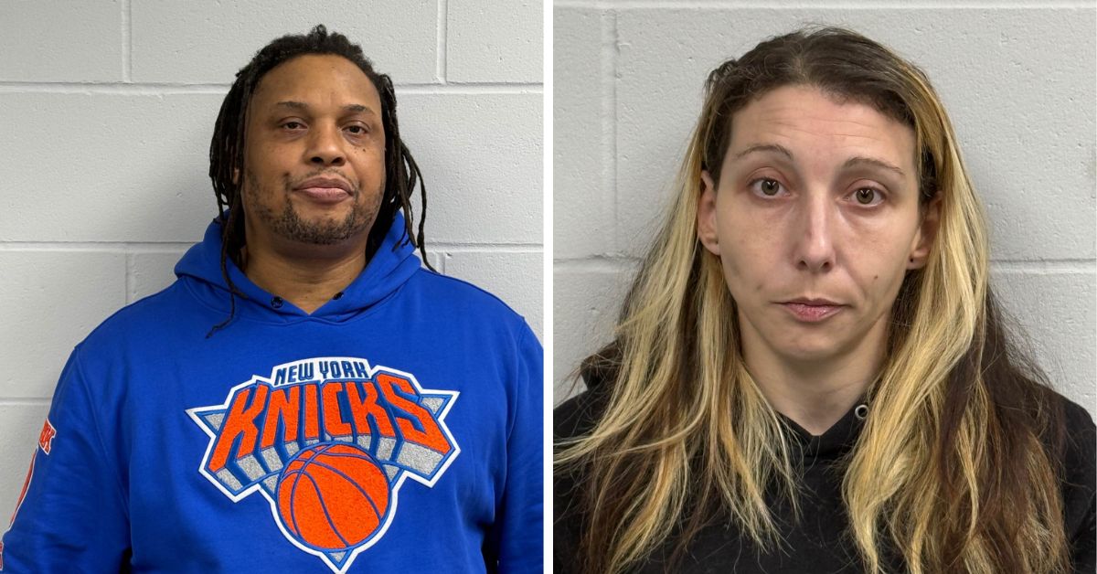 Side-by-side mugshots of James Jones and Kelly-Sandra Bove, both taken against a light gray cinderblock wall. Jones is wearing a blue New York Knicks hoodie, and Bove has long, highlighted hair and is dressed in black.