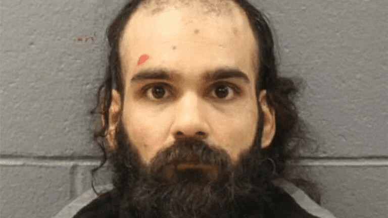 Mugshot of Francisco Severo Torres, with a beard and thinning hair, facing forward with a red mark on his forehead. Photo credit: Massachusetts State Police via AP.