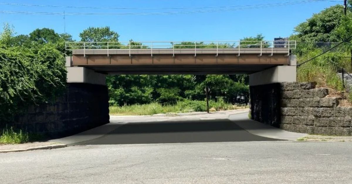 Digital rendering of the MBTA’s replacement South Elm Street Bridge in Haverhill, showing a new single-span steel bridge with a ballasted deck above a two-lane road and sidewalk.